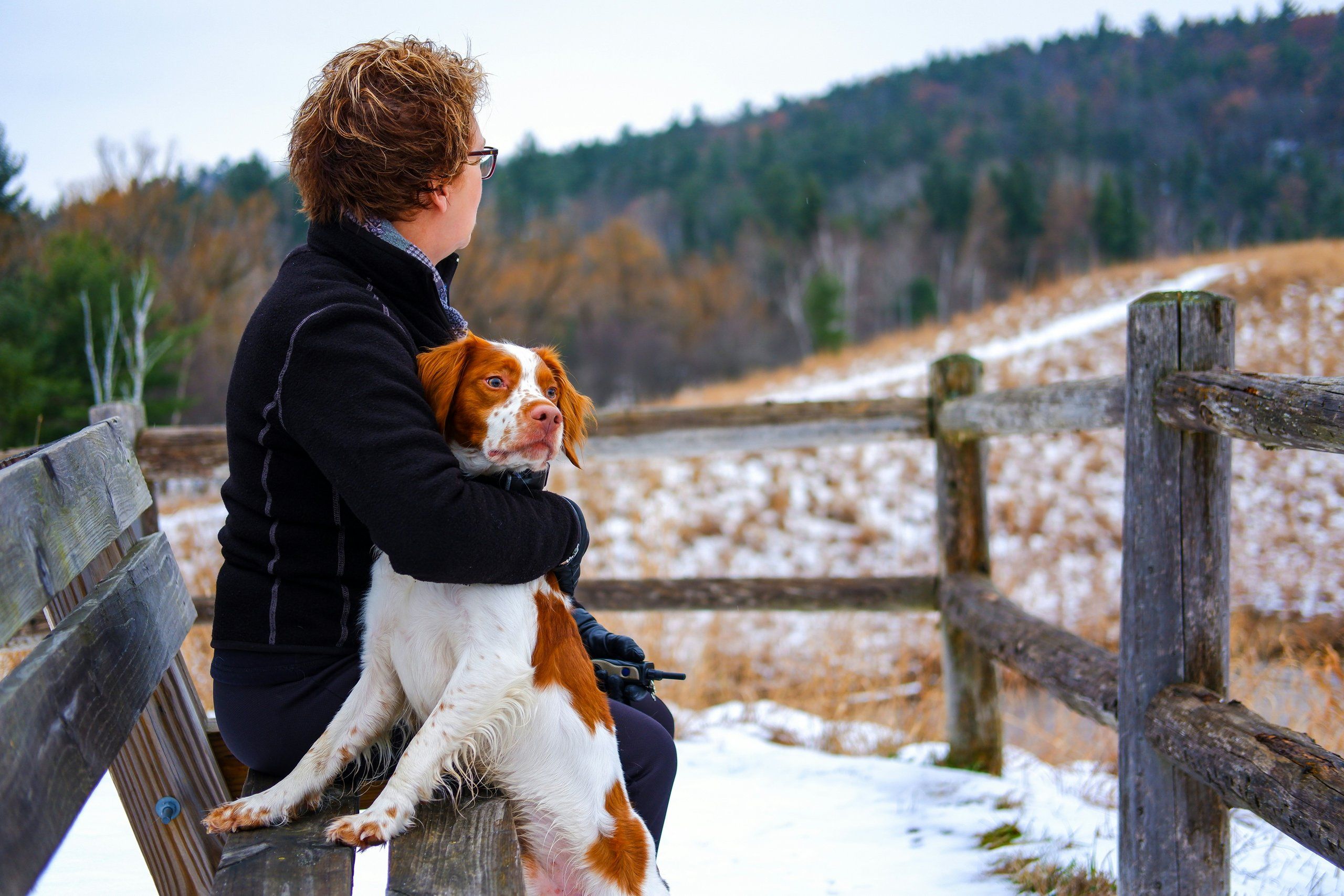 A friendly person outdoors with a dog
