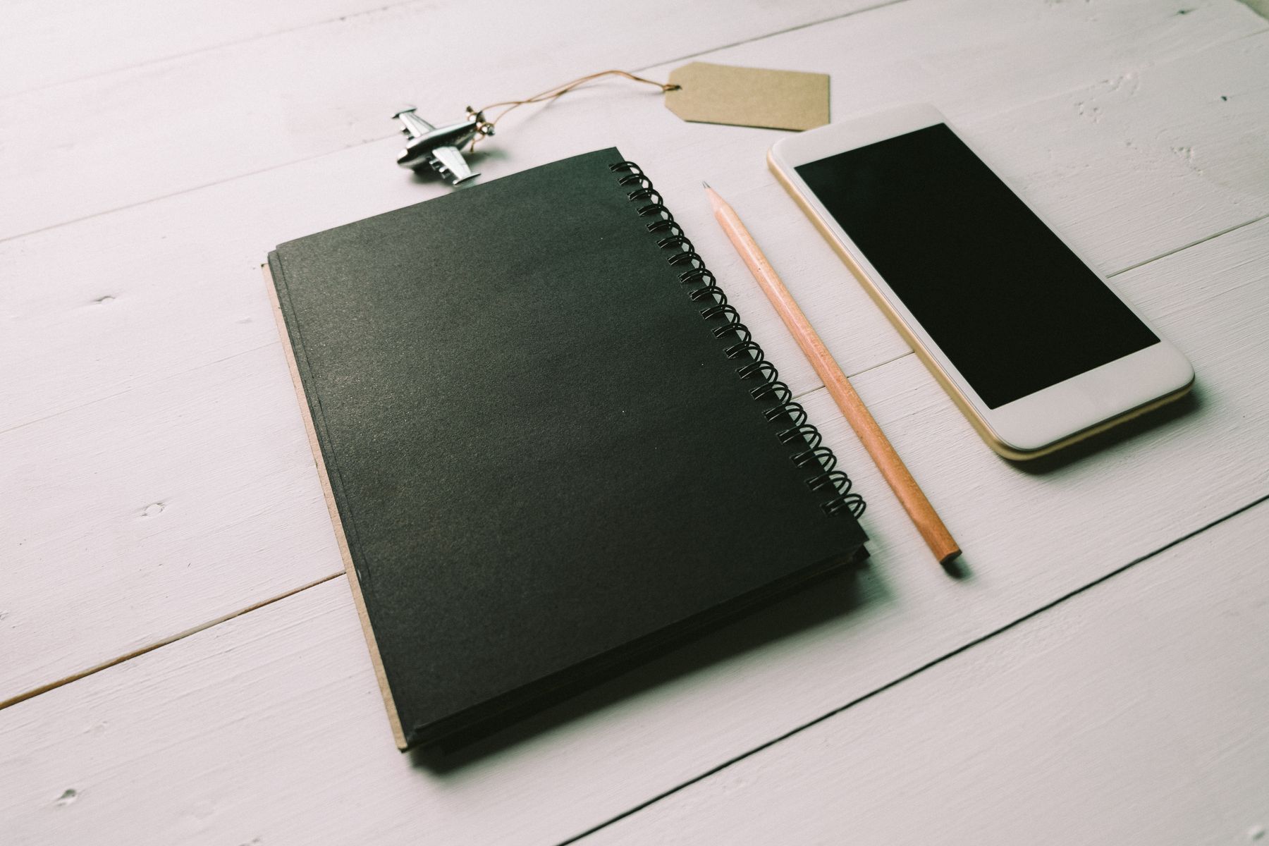 Travel documents and a phone on a wooden table