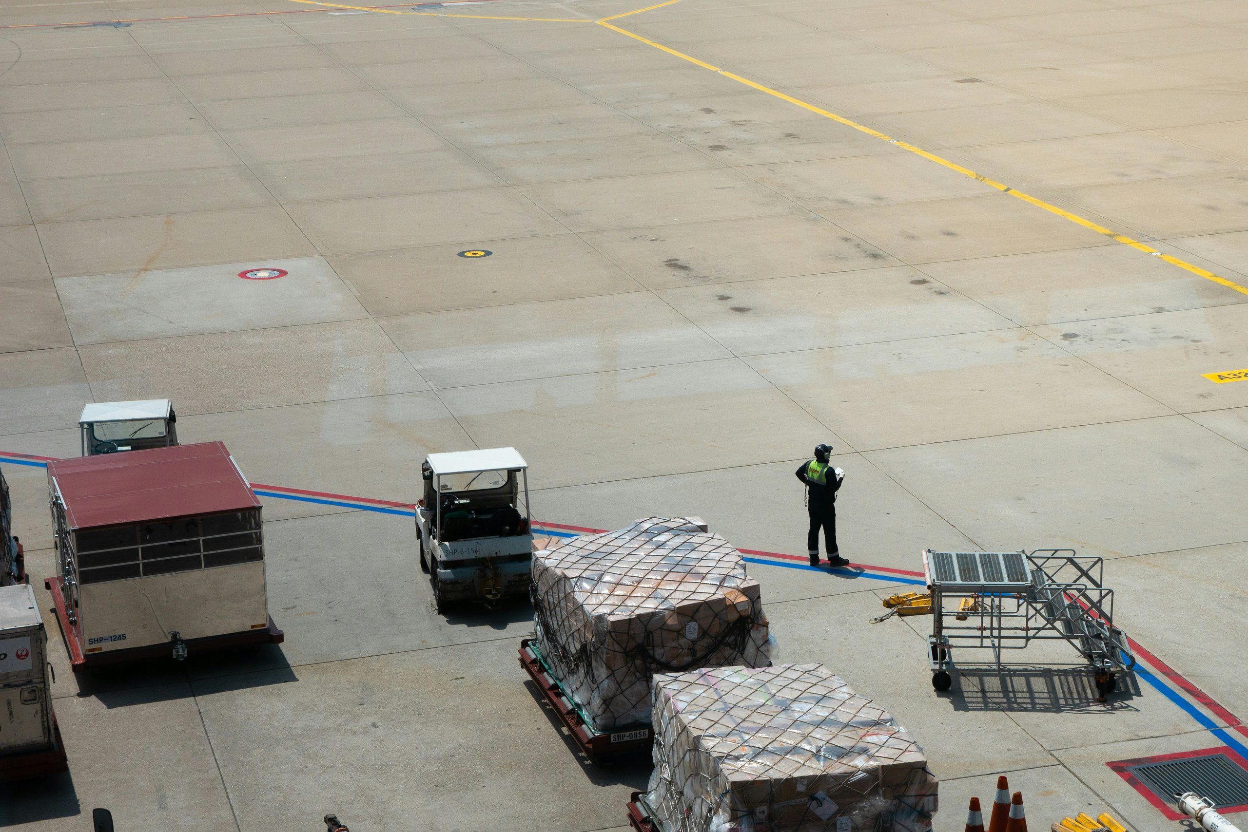 An airline crate on a cart at the airport